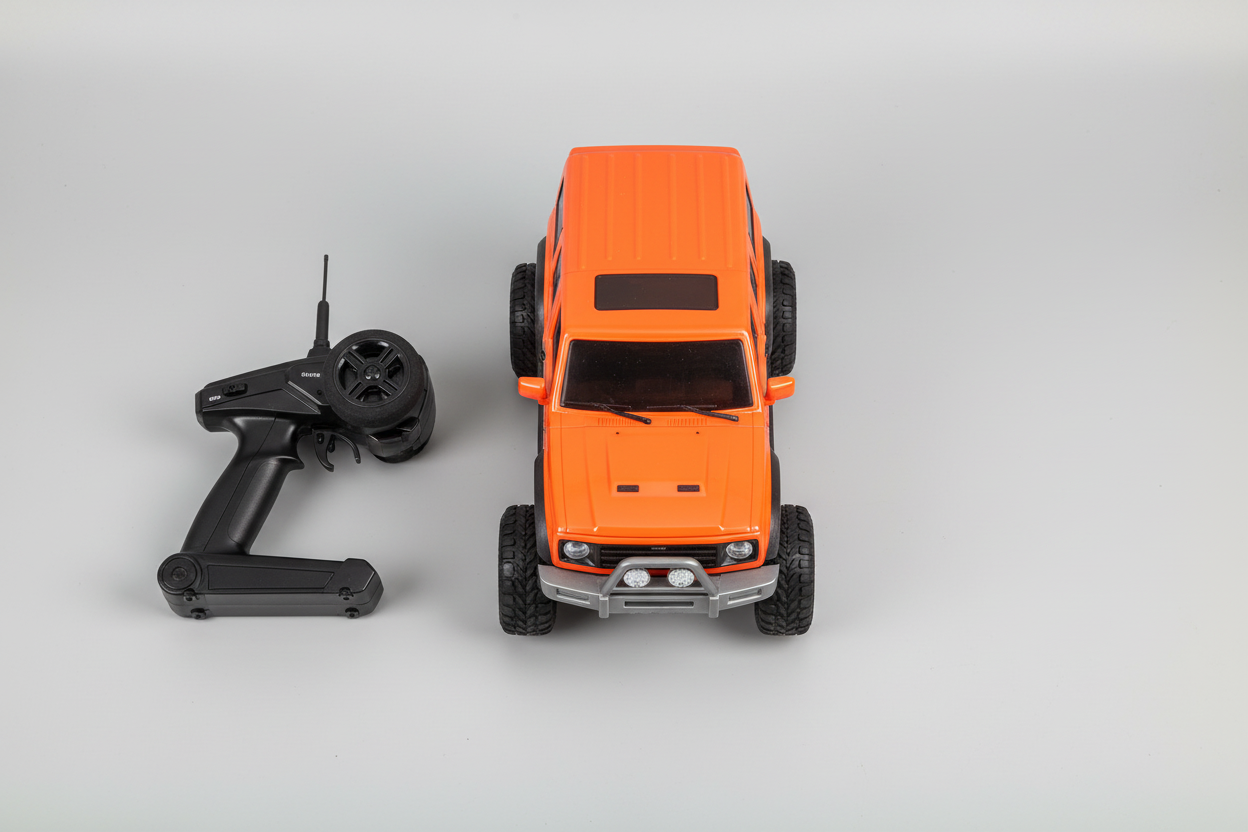 Flat lay of RC car and controller on grey surface